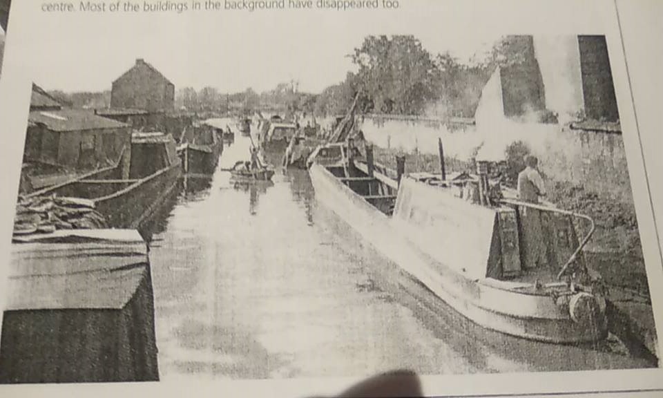An old black and white photo of Hardy outside Tooley's yard on the water