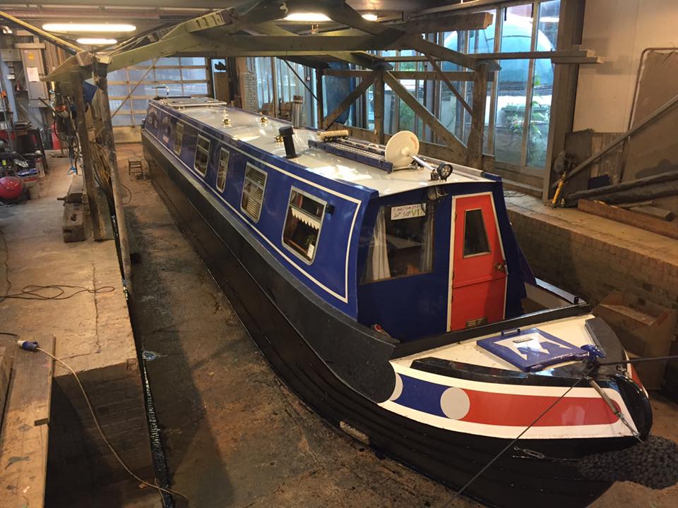 Modern narrowboat sitting in the dry dock